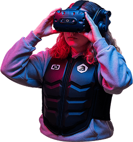 Person playing Hologate virtual reality shooting game inside immersive VR gaming zone with neon lights