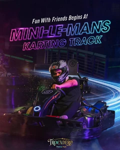 Indoor go kart racing experience at Mini Le Mans karting track with driver wearing helmet